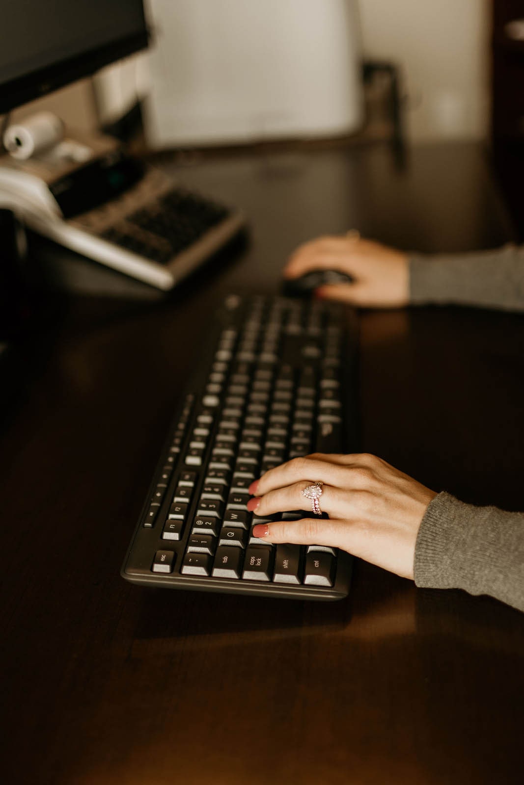 A close-up photo of a TDC employee doing work on her computer